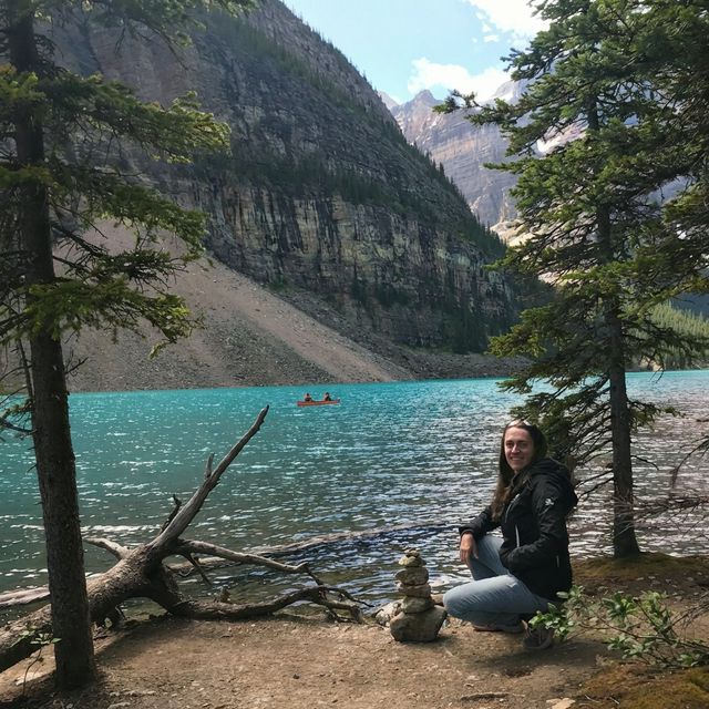 Karen with a cairn in the woods